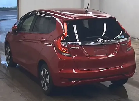 2017 Honda Fit Hybrid red hatchback, rear view, showing hatch design