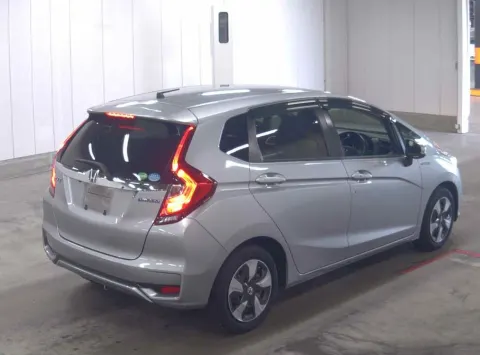 Honda Fit Hybrid 2018 silver hatchback, interior dashboard view, showing automatic transmission, available in Musina.