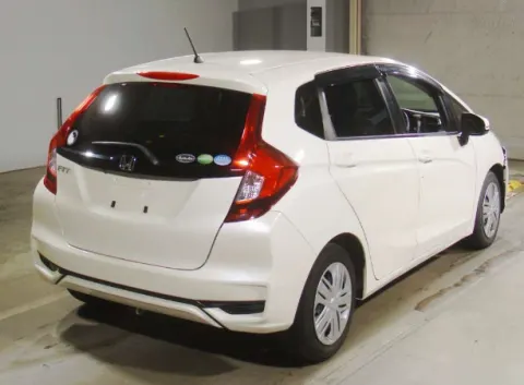 White Honda Fit 2018 hatchback, rear view, parked at dealership in Musina area.