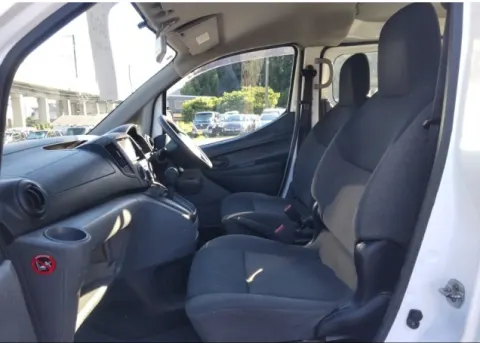 Engine bay of a 2018 Nissan Vanette NV200 van, showing the 1.6L petrol engine.