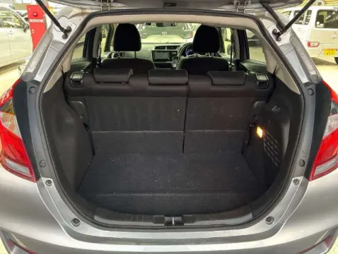 Engine bay of a 2019 Honda Fit Hybrid, 1.5L hybrid powertrain, silver exterior, for sale near Musina.
