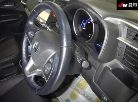 Honda Fit Hybrid 2017 white hatchback, interior dashboard view, with automatic gear selector