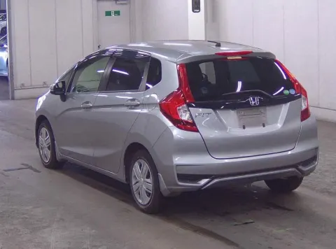 Rear view of a silver Honda Fit 2017 hatchback
