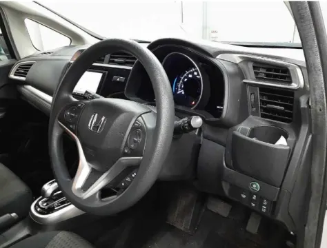 Dashboard view of a 2018 Honda Fit Hybrid showing instrument cluster.