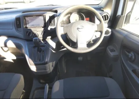 Front seats of a white 2018 Nissan Vanette NV200 van, showing the cabin space.
