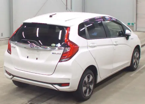 Rear view of a white 2018 Honda Fit Hybrid showing the hatchback design.