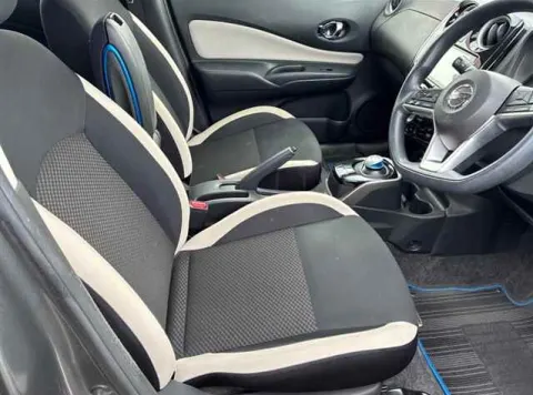 Interior of Nissan Note e-Power 2017, showing dashboard and steering wheel, right-hand drive.