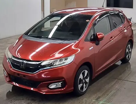 2017 Honda Fit Hybrid red hatchback, interior dashboard view with LCD screen