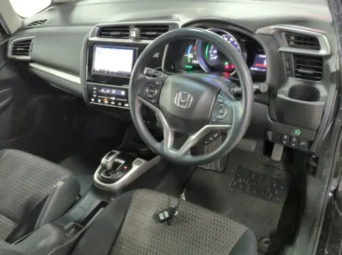 2017 Honda Fit Hybrid hatchback in Pearl Black, side view, at Musina dealership