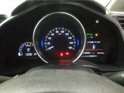 Honda Fit 2017 silver hatchback in a showroom setting