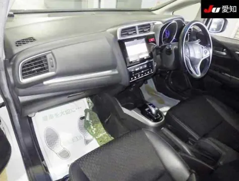 Honda Fit Hybrid 2017 white hatchback, side profile, showing compact design