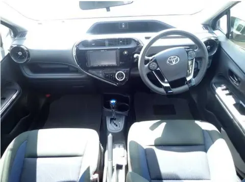 Engine bay of a 2017 Toyota Aqua hybrid, showing the hybrid system components.