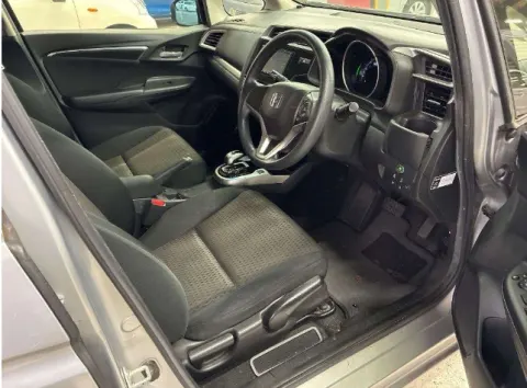 Side profile of a silver 2019 Honda Fit Hybrid, a compact hatchback with automatic transmission, available near Musina.